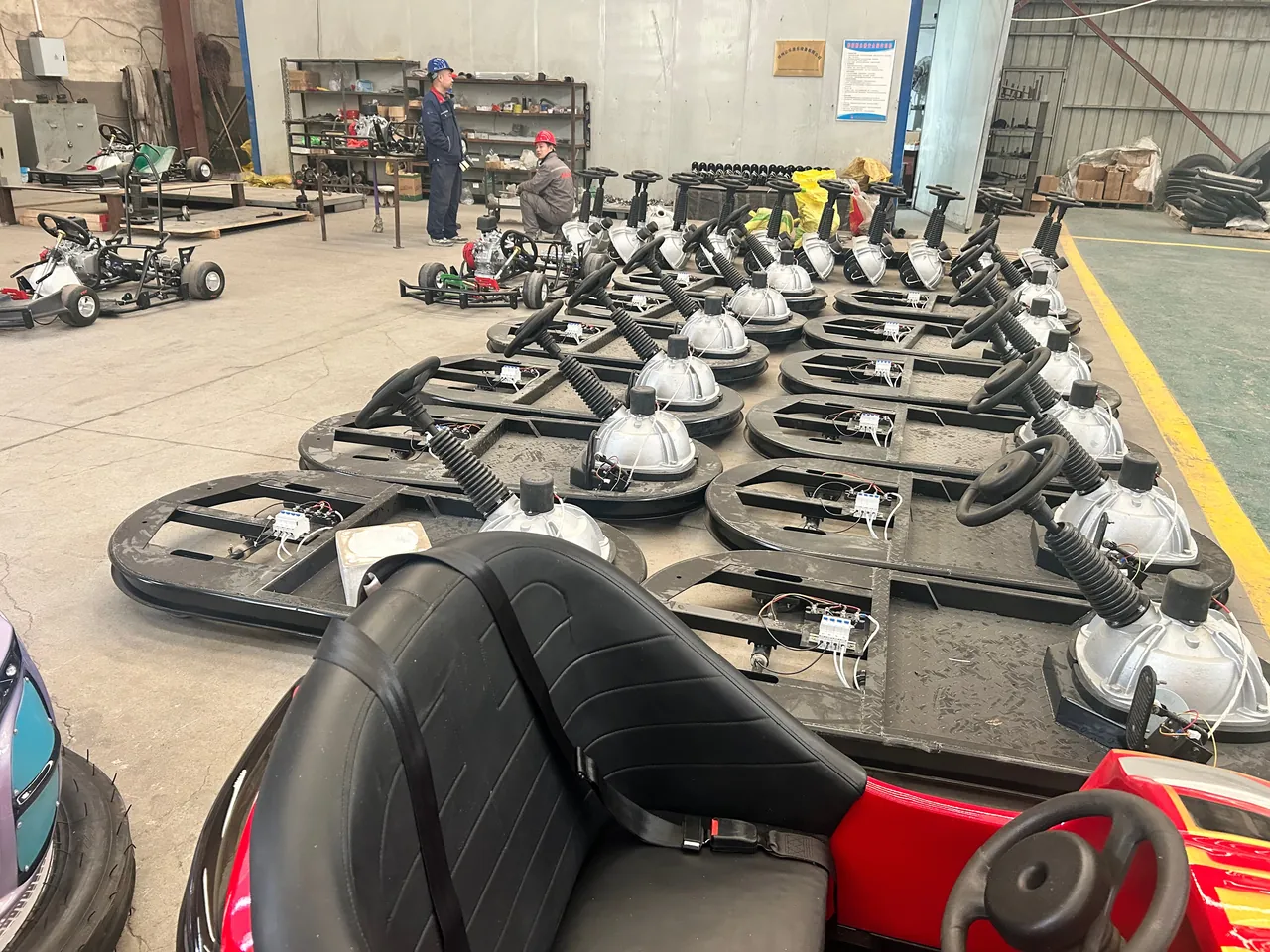 Rows of bumper car chassis in assembly at the XL Amusement Ride factory in Zhengzhou