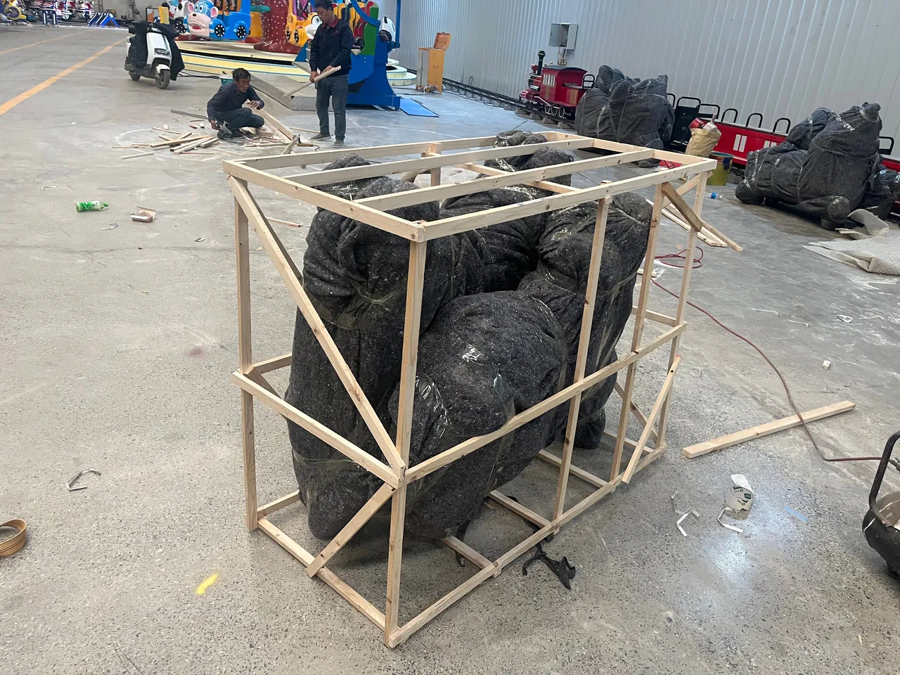 Horses and canopy panels crated for ocean freight — each horse bagged, foam-wrapped and boxed in a steel-reinforced wooden crate.