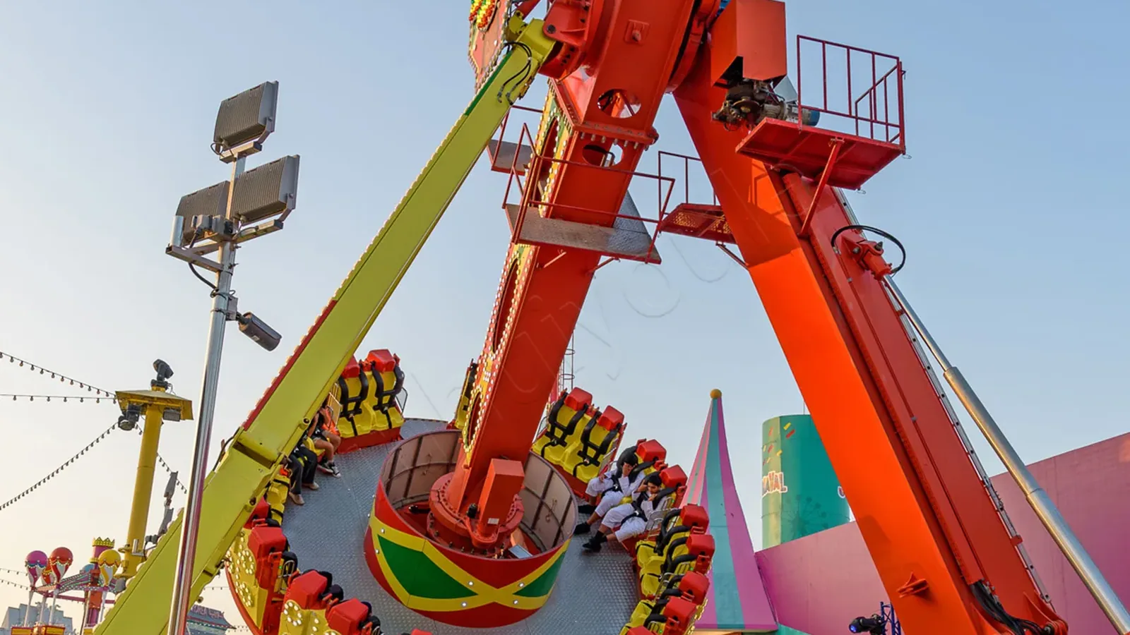 A Voyager pendulum ride with riders inverted mid-swing