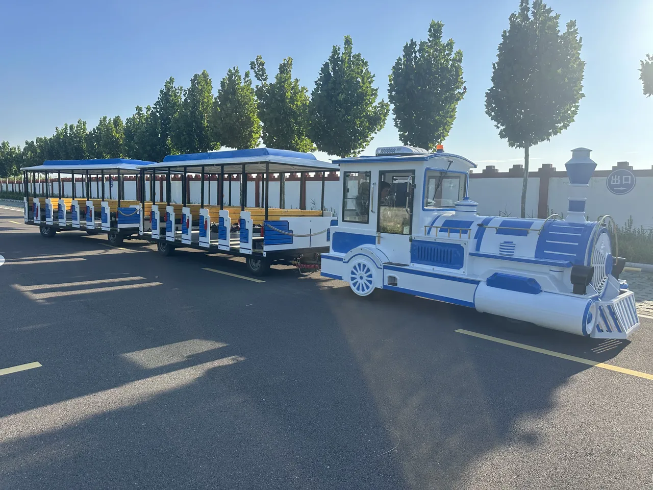 Electric trackless sightseeing train with two carriages in a park