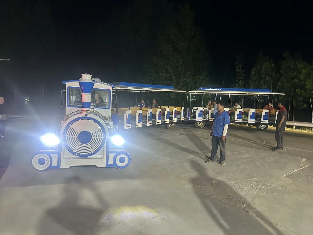 Trackless sightseeing train at night with the lighting switched on